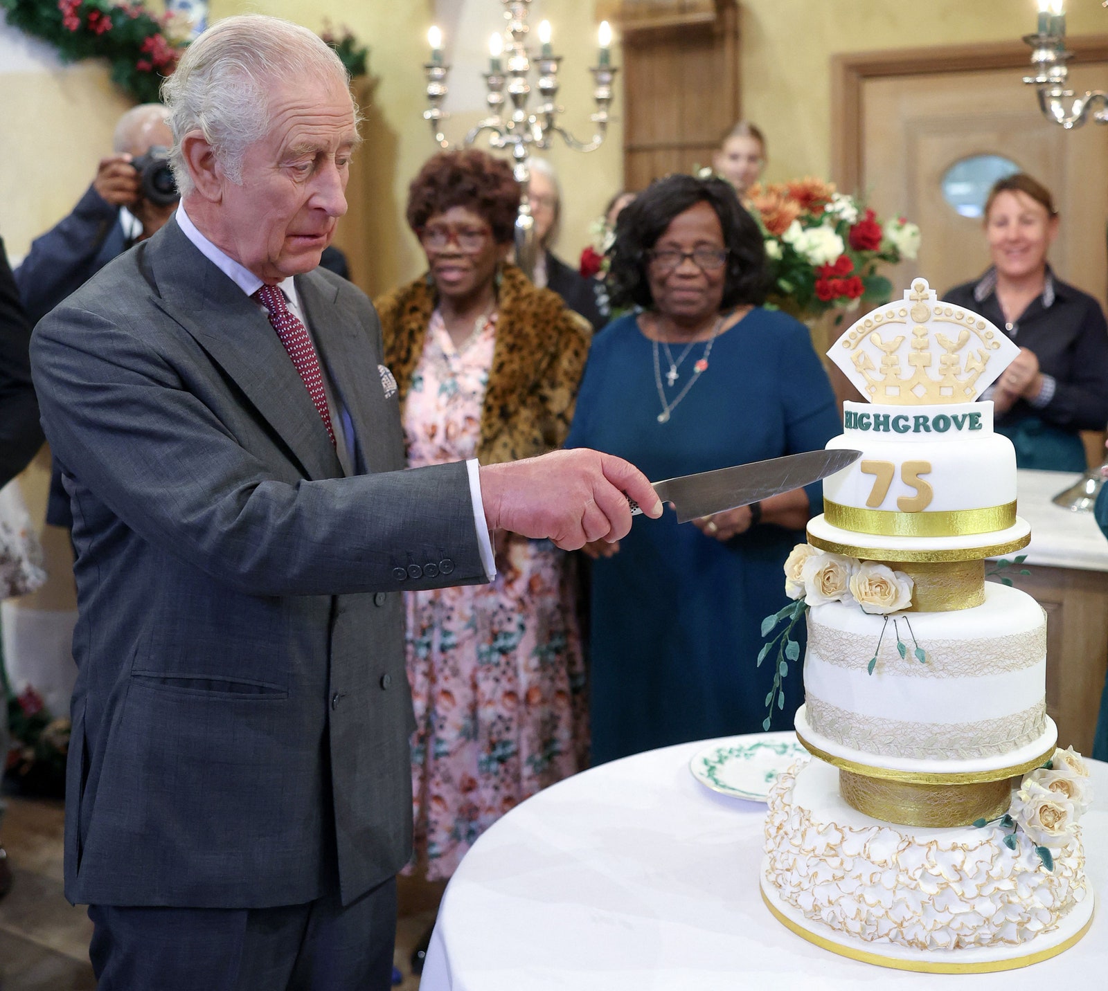 Le roi Charles III réagit en coupant un gâteau d'anniversaire alors qu'il assiste à la fête de son 75e anniversaire organisée par le prince...