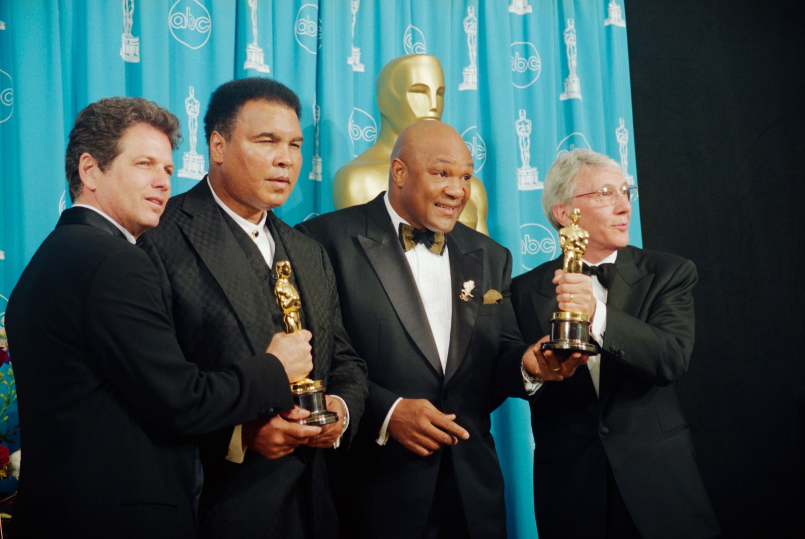 L'image peut contenir des accessoires de Muhammad Ali George Foreman Leon Gast Espoir formel Tie People Personne adulte et lunettes