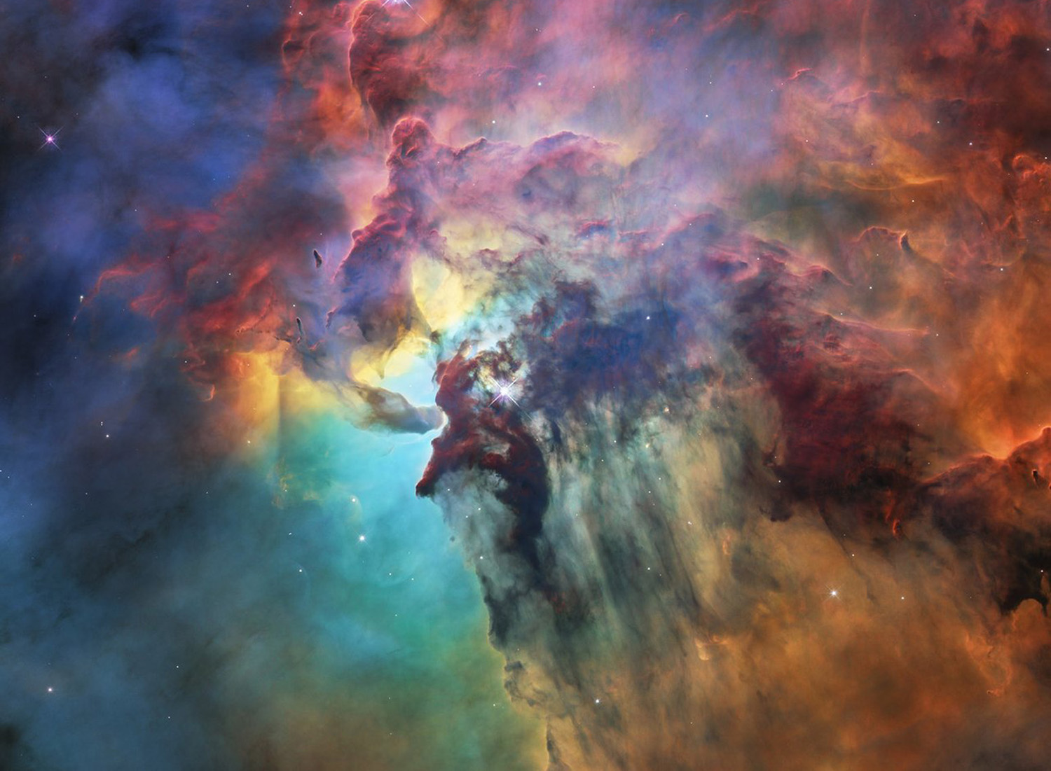 Voyez comment le télescope spatial Hubble révolutionne toujours l'astronomie Une image vibrante d'une nébuleuse, présentant des nuages tourbillonnants de gaz et de poussière dans des tons de rouge, d'orange, de bleu et de violet, avec des étoiles dispersées partout.