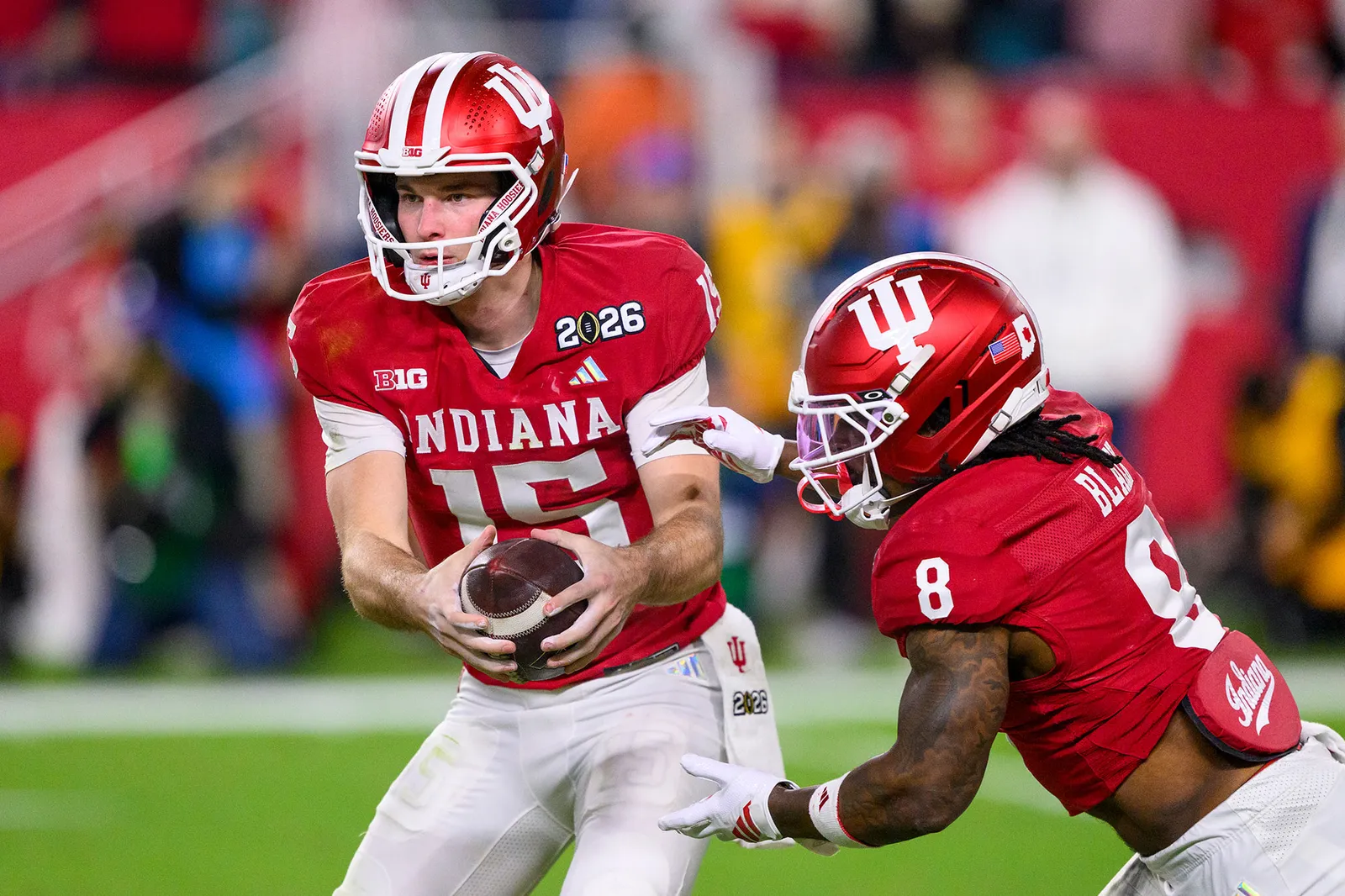 L'image peut contenir un ballon de rugby, un ballon de rugby, un casque de sport, un football américain, une personne et une personne jouant au football américain.
