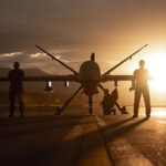 432nd Wing/432nd Air Expeditionary Wing Airmen pose with an MQ-9 Reaper for a photo at Creech Air Force Base, Nev., Nov. 19, 2019. The MQ-9 and its aircrew are one of the most demanded U.S. Air Force assets due to its ability to be employed primarily against dynamic targets and secondarily as an intelligence collection asset. (U.S. Air Force photo by Airman 1st Class William Rio Rosado)