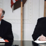cc White House Photographic Office, modified, https://commons.wikimedia.org/wiki/File:Reagan_and_Gorbachev_signing.jpg, President Ronald Reagan and Mikhail Gorbachev.