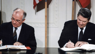 cc White House Photographic Office, modified, https://commons.wikimedia.org/wiki/File:Reagan_and_Gorbachev_signing.jpg, President Ronald Reagan and Mikhail Gorbachev.