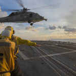 SOUTH CHINA SEA (July 22, 2016) Sailors signal to an MH-60S Sea Hawk helicopter attached to the “Golden Falcons” of Helicopter Sea Combat Squadron (HSC) 12 as it hovers over the flight deck of the Arleigh-Burke-class guided-missile destroyer USS McCampbell (DDG 85) during a visit, board, search and seizure training exercise. McCampbell is on patrol with the Carrier Strike Group Five (CSG 5) in the U.S. 7th Fleet area of responsibility supporting security and stability in the Indo-Asia-Pacific. (U.S. Navy photo by Mass Communication Specialist 3rd Class Elesia K. Patten/Released)160722-N-WM647-202 Join the conversation: http://www.navy.mil/viewGallery.asp http://www.facebook.com/USNavy http://www.twitter.com/USNavy http://navylive.dodlive.mil http://pinterest.com https://plus.google.com