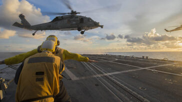 SOUTH CHINA SEA (July 22, 2016) Sailors signal to an MH-60S Sea Hawk helicopter attached to the “Golden Falcons” of Helicopter Sea Combat Squadron (HSC) 12 as it hovers over the flight deck of the Arleigh-Burke-class guided-missile destroyer USS McCampbell (DDG 85) during a visit, board, search and seizure training exercise. McCampbell is on patrol with the Carrier Strike Group Five (CSG 5) in the U.S. 7th Fleet area of responsibility supporting security and stability in the Indo-Asia-Pacific. (U.S. Navy photo by Mass Communication Specialist 3rd Class Elesia K. Patten/Released)160722-N-WM647-202 Join the conversation: http://www.navy.mil/viewGallery.asp http://www.facebook.com/USNavy http://www.twitter.com/USNavy http://navylive.dodlive.mil http://pinterest.com https://plus.google.com
