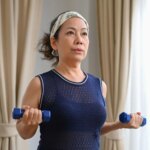 Middle Aged Woman Exercising Dumbells