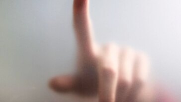 Fingertip Touches Fogged Glass