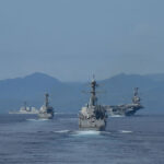 140927-N-GW918-230 PHILIPPINE SEA (Sep. 27, 2014) The Carl Vinson Carrier Strike Group transiting the Surigao Strait in the Philippines as seen from the Ticonderoga-class guided-missile cruiser USS Bunker Hill (CG 52). Bunker Hill is deployed as part of the Carl Vinson Carrier Strike Group supporting maritime security operations, strike operations in Iraq and Syria as directed, and theater security cooperation efforts in the U.S. 5th Fleet area of responsibility. (U.S. Navy photo by Mass Communication Specialist 1st Class LaTunya Howard/Released)