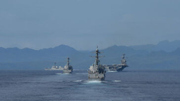 140927-N-GW918-230 PHILIPPINE SEA (Sep. 27, 2014) The Carl Vinson Carrier Strike Group transiting the Surigao Strait in the Philippines as seen from the Ticonderoga-class guided-missile cruiser USS Bunker Hill (CG 52). Bunker Hill is deployed as part of the Carl Vinson Carrier Strike Group supporting maritime security operations, strike operations in Iraq and Syria as directed, and theater security cooperation efforts in the U.S. 5th Fleet area of responsibility. (U.S. Navy photo by Mass Communication Specialist 1st Class LaTunya Howard/Released)