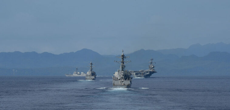 140927-N-GW918-230 PHILIPPINE SEA (Sep. 27, 2014) The Carl Vinson Carrier Strike Group transiting the Surigao Strait in the Philippines as seen from the Ticonderoga-class guided-missile cruiser USS Bunker Hill (CG 52). Bunker Hill is deployed as part of the Carl Vinson Carrier Strike Group supporting maritime security operations, strike operations in Iraq and Syria as directed, and theater security cooperation efforts in the U.S. 5th Fleet area of responsibility. (U.S. Navy photo by Mass Communication Specialist 1st Class LaTunya Howard/Released)