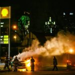 Firefighters Extinguishing Flames at a Gas Station