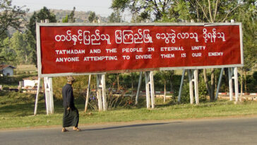 cc juls78, modified, https://commons.wikimedia.org/w/index.php?sort=last_edit_desc&search=Tatmadaw+filetype%3Abitmap&title=Special:Search&profile=advanced&fulltext=1&advancedSearch-current=%7B%22fields%22%3A%7B%22filetype%22%3A%22bitmap%22%7D%7D&ns0=1&ns6=1&ns12=1&ns14=1&ns100=1&ns106=1#/media/File:Propaganda,_Myanmar_2.jpg