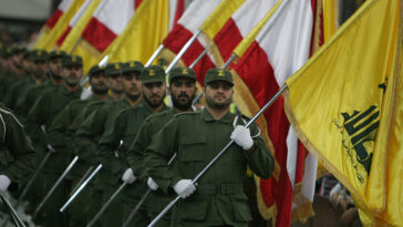 Hezbollah fighters in a ceremony; https://commons.wikimedia.org/wiki/File:Hezzzzbollah.jpgcc khamenei.ir, modified
