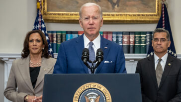 cc The White House, modified, https://commons.wikimedia.org/w/index.php?sort=last_edit_desc&search=president+biden+filetype%3Abitmap&title=Special%3ASearch&profile=advanced&fulltext=1&advancedSearch-current=%7B%22fields%22%3A%7B%22filetype%22%3A%22bitmap%22%7D%7D&ns0=1&ns6=1&ns12=1&ns14=1&ns100=1&ns106=1#/media/File:P20220708AS-0312_(52308746245)_(cropped).jpg ; President Joe Biden, joined by Vice President Kamala Harris, Secretary of Health and Human Services Xavier Beccera and Deputy Attorney General Lisa Monaco, delivers remarks in the Roosevelt Room of the White House Friday, July 8, 2022, prior to signing an executive order protecting access to reproductive healthcare services. (Official White House Photo by Adam Schultz)