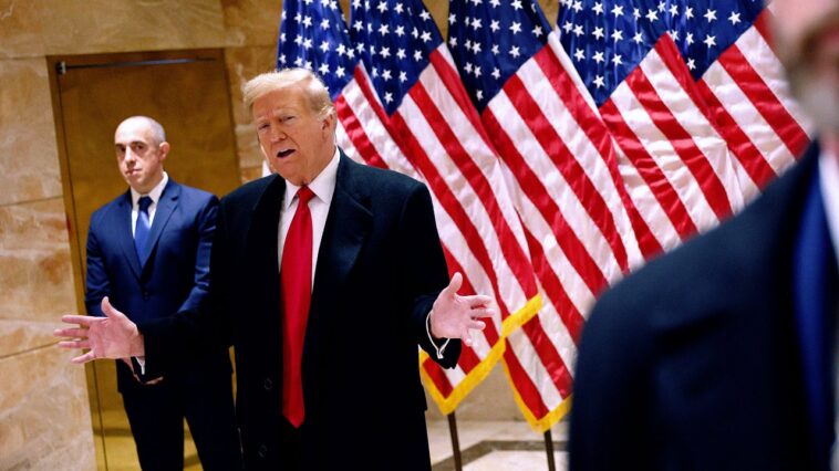 En se cachant et en faisant un clin d'œil, Donald Trump apprend que son procès pénal débutera le mois prochain