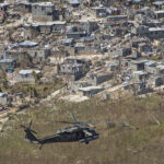 A U.S. Army UH-60 Black Hawk helicopter with Joint Task Force-Bravo’s 1st Battalion, 228th Aviation Regiment, deployed in support of Joint Task Force Matthew, flies toward a supply distribution point in Jeremie, Haiti, Oct. 10, 2016. JTF Matthew, a U.S. Southern Command-directed team, is comprised of Marines with Special Purpose Marine Air-Ground Task Force - Southern Command and soldiers from JTF-Bravo, and is deployed to Port-au-Prince at the request of the Government of Haiti on a mission to provide humanitarian and disaster relief assistance in the aftermath of Hurricane Matthew. (U.S. Marine Corps photo by Cpl. Kimberly Aguirre)