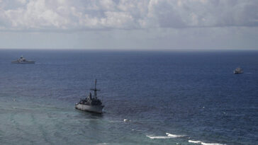 130122-N-ZZ999-001 SULU SEA, Philippines (Jan. 22, 2013) A U.S. Navy P-3 Orion provides aerial surveillance of the USS Guardian (MCM 5), which ran aground on Tubbataha Reef on Jan. 17. USNS Bowditch (T-AGS 62), left, and a Philippine Coast Guard ship, BRP Corregidor, right, are closely cooperating during ongoing efforts to safely recover Guardian while minimizing environmental effects to the reef. (U.S. Navy photo by Aircrewman Tactical Helicopters 3rd Class Geoffrey Trundell/Released)