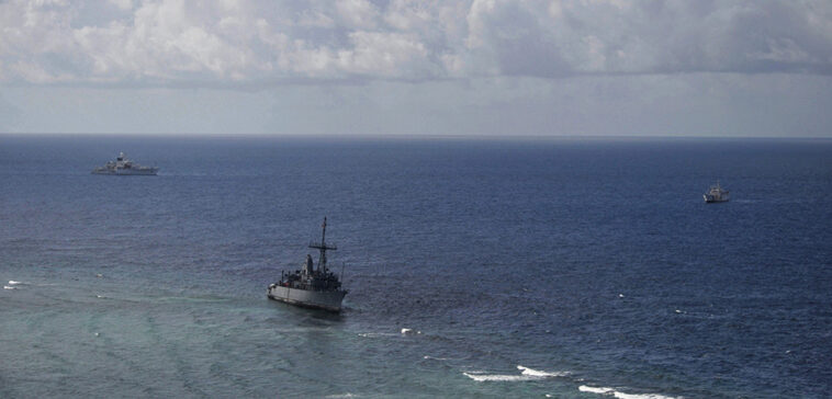 130122-N-ZZ999-001 SULU SEA, Philippines (Jan. 22, 2013) A U.S. Navy P-3 Orion provides aerial surveillance of the USS Guardian (MCM 5), which ran aground on Tubbataha Reef on Jan. 17. USNS Bowditch (T-AGS 62), left, and a Philippine Coast Guard ship, BRP Corregidor, right, are closely cooperating during ongoing efforts to safely recover Guardian while minimizing environmental effects to the reef. (U.S. Navy photo by Aircrewman Tactical Helicopters 3rd Class Geoffrey Trundell/Released)