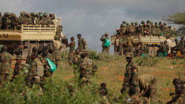 cc AMISOM Public Information, modified, AMISOM Public Information AMISOM & Somali National Army operation to capture Afgoye Corridor Day #5 03 Ugandan soldiers serving with the African Union Mission in Somalia (AMISOM) are seen on the the back of military trucks 25 May 2012 in the town of Afgoye to the west of the Somali capital Mogadishu as they prepare to deploy south of the town on the road to Merka. An joint-AMISOM and Somali National Army (SNA) offensive has driven the Al-Qaeda-affiliated extremist group Al Shabaab from the strategically important area of the Afgoye corridor, which the group used as a base to launch attacks inside Mogadishu and is also home to hundreds of thousands of refugees. With the extremists gone, the area is now secure for humantarian aid to reach the internally displaced peoples camps and opens the road between the agriculturally productive area of Afgoye and the Somali capital, allowing freedom of movement of goods, produce and people alike. AU-UN IST PHOTO / STUART PRICE.
