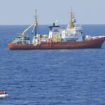 cc Flickr, modified, Commander, U.S. Naval For, 160729-N-ZE250-283 MEDITERRANEAN SEA (July 29, 2016) - Sailors assigned to USS Carney (DDG 64) provide security while members of the SOS Mediterranee ship MS Aquarius rescue migrants on a small craft in the Mediterranean Sea July 29, 2016. Carney, an Arleigh Burke-class guided-missile destroyer, forward deployed to Rota, Spain, is conducting a routine patrol in the U.S. 6th fleet area of operations in support of U.S. national security interests in Europe. (U.S. Navy photo by Mass Communication Specialist 3rd Class Weston Jones/Released)