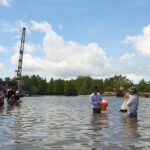 Students doing field work in Hau Giang Province and Can Tho City, learning to collect data on surface-water and riverbed water and sediment quality changes. Photo credit: Nguyen Minh Quang, co-founder Mekong Environment Forum, modified, all rights reserved for author.