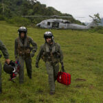 110810-N-RM525-443 BAJO BLAY, Costa Rica (Aug. 10, 2011) Costa Rica Police Air Patrol Officer Capt. George Lozano, left, Naval Air Crewman 3rd Class Joe Wainscott and Chief Naval Air Crewman Justin Crowe head toward a village to assist an injured boy in Bajo, Blay, Costa Rica, during Continuing Promise 2011. Continuing Promise is a five-month humanitarian assistance mission to the Caribbean, Central and South America. (U.S. Navy photo by Mass Communication Specialist 2nd Class Jonathen E. Davis/Released)