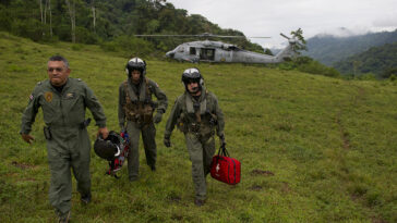 110810-N-RM525-443 BAJO BLAY, Costa Rica (Aug. 10, 2011) Costa Rica Police Air Patrol Officer Capt. George Lozano, left, Naval Air Crewman 3rd Class Joe Wainscott and Chief Naval Air Crewman Justin Crowe head toward a village to assist an injured boy in Bajo, Blay, Costa Rica, during Continuing Promise 2011. Continuing Promise is a five-month humanitarian assistance mission to the Caribbean, Central and South America. (U.S. Navy photo by Mass Communication Specialist 2nd Class Jonathen E. Davis/Released)