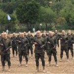 Fighters from the Lebanese militant group Hezbollah carried out a training exercise in Aaramta village in the Jezzine District, southern Lebanon, on Sunday, May 21, 2023. The show of force came ahead of “Liberation Day,” the annual celebration of the withdrawal of Israeli forces from south Lebanon on May 25, 2000, and in the wake of a recent escalation of the Israel-Palestine conflict in the Gaza Strip. Tansim news, modified, https://he.m.wikipedia.org/wiki/%D7%A7%D7%95%D7%91%D7%A5:2023_Hezbollah_drill_in_Aaramta_01.jpg