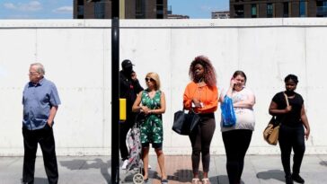 People waiting at traffic lights Description People waiting at traffic lights. Lewisham, London, England, UK