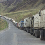 cc Clay Gilliland, modified, Line of trucks from Georgia and Armenia waiting to enter Russia Just south of Kazbegi; https://flickr.com/photos/26781577@N07/37109052573/in/photolist-YxcAtg-ezBaKz-oGJozX-oJt7qU-Zhzo9C-ZhznCs-2aTLqxG-CfJVAj-2aDbPpB-PRyLHG-gNSGzW-2aB2NVF-Zj3kMj-2bZC4UX-2bXuoHC-2nLvHZc-Zj3fxS-EnMPfs-DsohWo-DRC6vX-2kLVsmD-2kLRMmw-2iJ7FcS-2iJ7FgK-2iJ7Ffx-fhe3Cf-7orsHx-7ovmwS-PcL7bb-rm2mVZ-noiDg9-edhvaJ-2mcAJW2-2mcx3AR-edbRVF-ee7k1G-edbRQe-ecxge3-2gCFPBb-ee4wud-LVthDD-ecrCW2-KKgAvs-2gCFPGX-2gCFPEN-edbRCn-ecrD4X-dVgj8x-2mcWBES-afDKNz