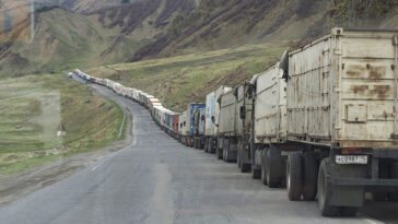 cc Clay Gilliland, modified, Line of trucks from Georgia and Armenia waiting to enter Russia Just south of Kazbegi; https://flickr.com/photos/26781577@N07/37109052573/in/photolist-YxcAtg-ezBaKz-oGJozX-oJt7qU-Zhzo9C-ZhznCs-2aTLqxG-CfJVAj-2aDbPpB-PRyLHG-gNSGzW-2aB2NVF-Zj3kMj-2bZC4UX-2bXuoHC-2nLvHZc-Zj3fxS-EnMPfs-DsohWo-DRC6vX-2kLVsmD-2kLRMmw-2iJ7FcS-2iJ7FgK-2iJ7Ffx-fhe3Cf-7orsHx-7ovmwS-PcL7bb-rm2mVZ-noiDg9-edhvaJ-2mcAJW2-2mcx3AR-edbRVF-ee7k1G-edbRQe-ecxge3-2gCFPBb-ee4wud-LVthDD-ecrCW2-KKgAvs-2gCFPGX-2gCFPEN-edbRCn-ecrD4X-dVgj8x-2mcWBES-afDKNz