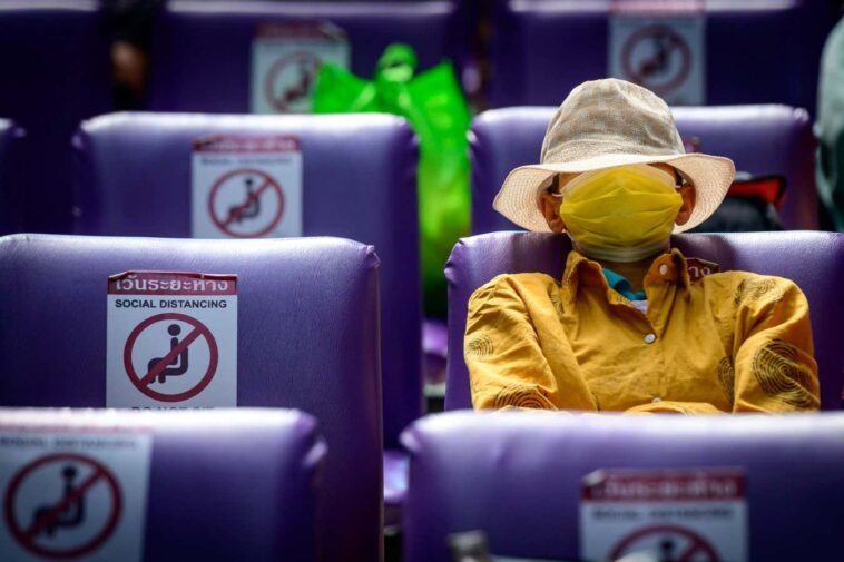 TOPSHOT - A passenger wearing a protective face mask waits for his train at Hua Lamphong Central Railway Station in Bangkok on January 4, 2021, as health officials in Thailand announced on Monday 745 new Covid-19 coronavirus cases, the country