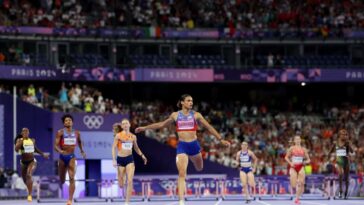 PARIS, FRANCE - AUGUST 08: (EDITORS NOTE: Image was captured using a remote camera) Sydney McLaughlin-Levrone of Team United States crosses the finish line to win the gold medal with new World Record after competing in the Women