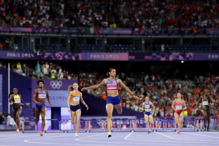 PARIS, FRANCE - AUGUST 08: (EDITORS NOTE: Image was captured using a remote camera) Sydney McLaughlin-Levrone of Team United States crosses the finish line to win the gold medal with new World Record after competing in the Women