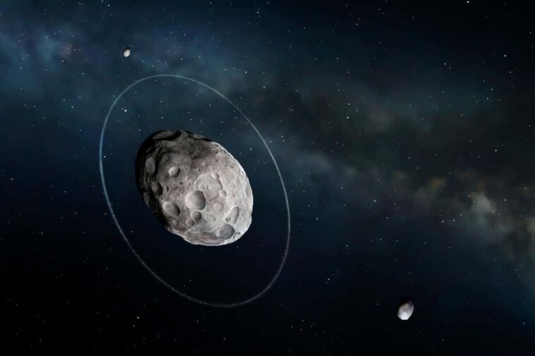 KHKRFM Haumea and moons, illustration. Haumea is a dwarf planet in the Kuiper Belt. It is noted for its elongated shape, somewhat like a rugby ball. It is orbited by at least two moons and a narrow ring of rocky particles.