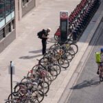 A cyclist unlocks his bike on Silk Street in the City of London, the capital