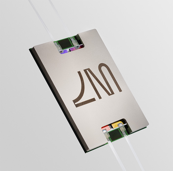 Un composant informatique de couleur argentée avec quatre câbles de couleur transparente qui y sont fixés.