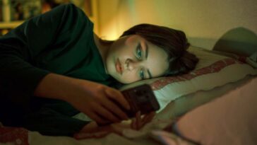 Portrait of a teenage girl talking with mobile phone. Concept of depression, loneliness, problems of adolescence. Selective focus