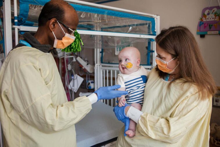 KJ after an infusion with researchers Rebecca Ahrens-Nicklas and Kiran Musunuru