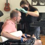 The man being connected to the brain-computer interface system