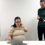 Trial participant Emily Wheldon with one of the researchers as she practiced attempting to move the lost fingers from her amputated arm before going into an MRI scanner