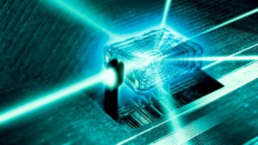 Quantum computer core. Light rays passing through the nanoscale crystal core of a quantum computer. Quantum computers, which are under development, are based on quantum mechanics and the principle of representing information in quantum bits (qubits) using quantum properties. This could involve optical properties of chemically doped crystals, like the one shown here. Quantum computing has the potential to massively increase computing power.