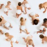 A large group of babies crawling in nappies or diapers