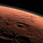 computer-generated view of Mars at the boundary between darkness and daylight, with an area including Gale Crater