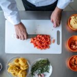 Directly above view of a chef chopping tomatoes
