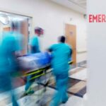 Doctor wheeling patient