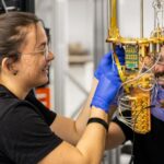 Two quantum engineers working on one of the systems at Qilimanjaro?s multimodal quantum data center.