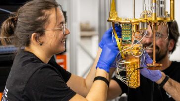 Two quantum engineers working on one of the systems at Qilimanjaro?s multimodal quantum data center.