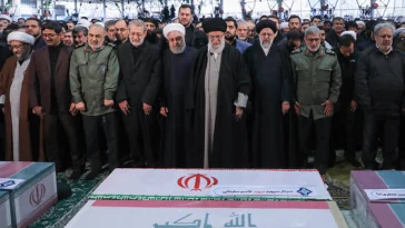 Officials grieve at the funeral of Qasem Soleimani. Hassan Rouhani, Ali Khamenei, and Ebrahim Raisi are seen in the middle of the front row.; modified, khamenei.ir, https://fr.wikipedia.org/wiki/Fichier:Qasem_Soleimani_funeral_2.jpg