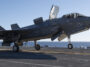 An F-35B Lightning II of Air Test and Evaluation Squadron 23 (VX-23) on the flight deck of JS Kaga (DDH-184) during F-35B developmental testing off Southern California, October 2024. US Navy photo by Dane Wiedmann, public domain, modified, https://commons.wikimedia.org/wiki/File:F-35B_launches_from_JS_Kaga_during_sea_trials-2.jpg